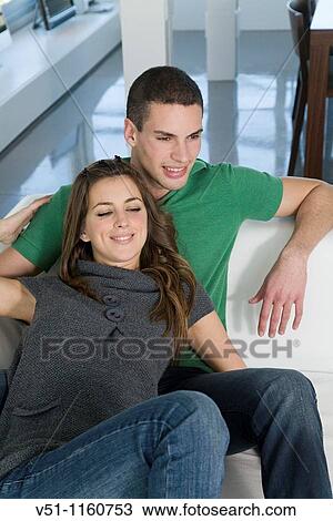 Portrait of a young couple on the sofa View Large Photo Image Stock Image - Portrait of a young couple on the sofa. Fotosearch