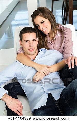 Portrait of a young couple on the sofa View Large Photo Image Stock Photo - Portrait of a young couple on the sofa. Fotosearch