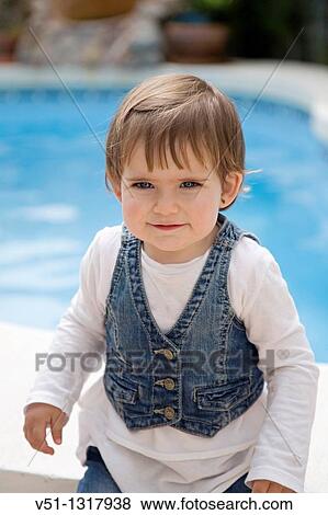 Stock Photo - Portrait of a young girl by the pool. Fotosearch