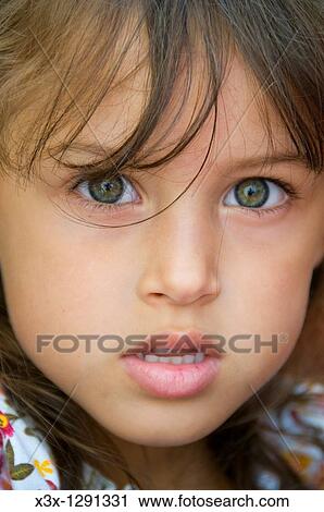 Portrait of a young girl looking at camera View Large Photo Image Stock Image - Portrait of a young girl looking at camera. Fotosearch