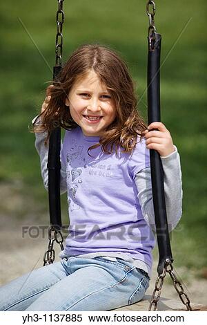 Portrait of a young girl playing at the playground View Large Photo Image Stock Photography - Portrait of a young girl playing at the playground. Fotosearch