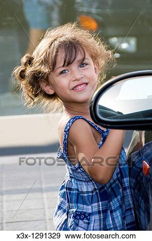 Portrait of a young girl smiling View Large Photo Image Stock Photo - Portrait of a young girl smiling. Fotosearch