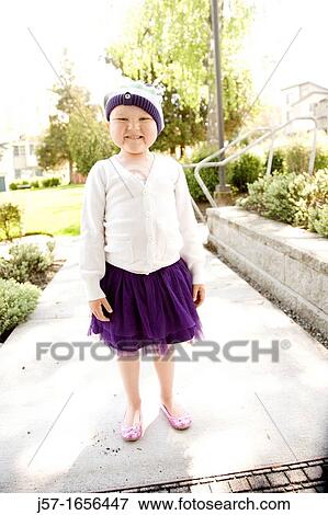 Portrait of a young girl with pediatric cancer leukaemia smiling at the camera standing outside her apartment door View Large Photo Image Stock Photo - Portrait of a young girl with pediatric cancer leukaemia smiling at the camera standing outside her apartment door. Fotosearch