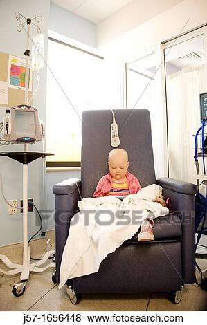 Portrait of a young girl with pediatric cancer leukimia sitting in an infusion chair at Seattle Children's Hospital reading a book View Large Photo Image Stock Photo - Portrait of a young girl with pediatric cancer leukimia sitting in an infusion chair at Seattle Children's Hospital reading a book. Fotosearch