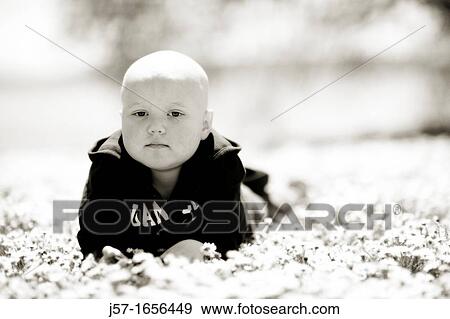 Portrait of a young girl with pediatric cancer leukaemia lying in a field of flowers She is bald from the side effects of chemo therapy View Large Photo Image Stock Photo - Portrait of a young girl with pediatric cancer leukaemia lying in a field of flowers She is bald from the side effects of chemo therapy. Fotosearch