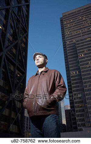 Stock Image - Portrait of a young man in an urban setting at dusk, San Francisco, California, USA. Fotosearch