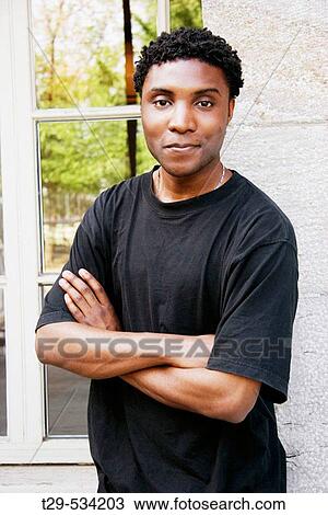 Portrait of a young man laughing View Large Photo Image Stock Image - Portrait of a young man laughing. Fotosearch