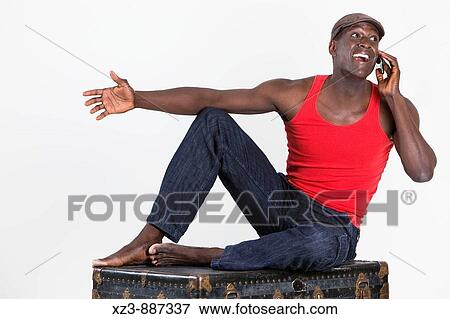 Portrait of a young man talking on the phone in the studio. View Large Photo Image Stock Photo - Portrait of a young man talking on the phone in the studio.. Fotosearch