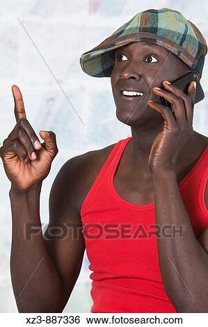 Portrait of a young man talking on the phone View Large Photo Image Stock Photograph - Portrait of a young man talking on the phone. Fotosearch