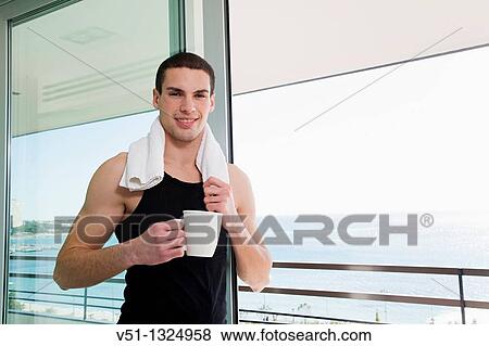 Portrait of a young man with a cup of coffee in a terrace View Large Photo Image Stock Photo - Portrait of a young man with a cup of coffee in a terrace. Fotosearch