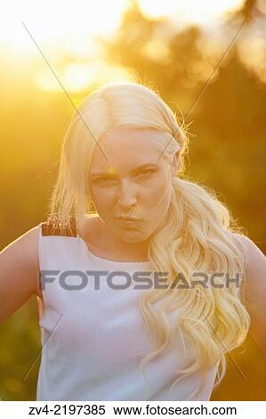 Portrait of a young woman at sunset. View Large Photo Image Stock Photography - Portrait of a young woman at sunset.. Fotosearch
