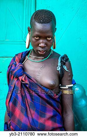 Portrait Of A Young Woman From The Mursi Tribe, Jinka, Omo Valley, Ethiopia. View Large Photo Image Stock Image - Portrait Of A Young Woman From The Mursi Tribe, Jinka, Omo Valley, Ethiopia.. Fotosearch