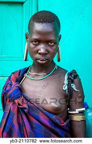 Portrait Of A Young Woman From The Mursi Tribe, Jinka, Omo Valley, Ethiopia. View Large Photo Image Stock Image - Portrait Of A Young Woman From The Mursi Tribe, Jinka, Omo Valley, Ethiopia.. Fotosearch