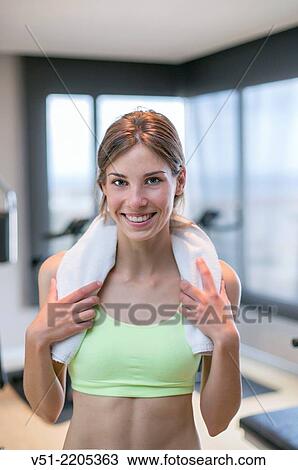 Portrait of a young woman in fitness center smiling at camera View Large Photo Image Stock Image - Portrait of a young woman in fitness center smiling at camera. Fotosearch
