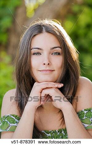 Stock Image - Portrait of a young woman looking at camera. Fotosearch