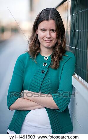 Portrait of a young woman near a fence. View Large Photo Image Stock Image - Portrait of a young woman near a fence.. Fotosearch