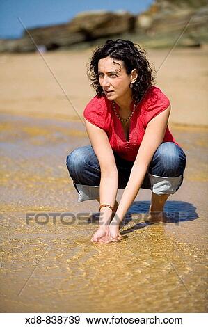 Stock Photo - Portrait of a young woman on the beach. Fotosearch