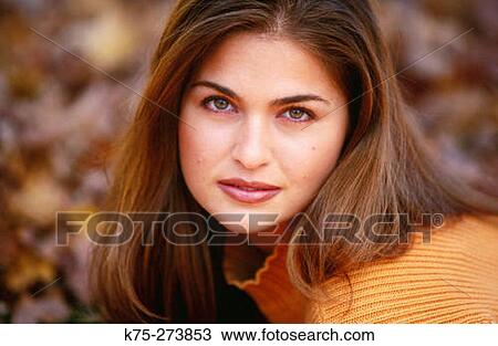 Stock Image - Portrait of a young woman outdoors. Fotosearch