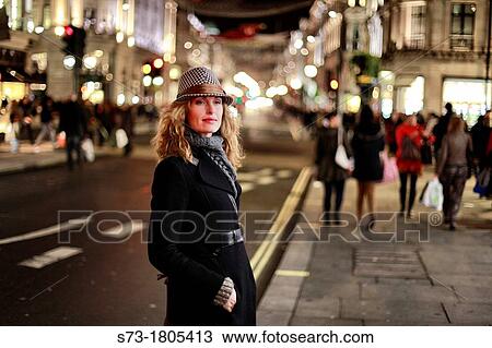 Portrait of a young woman smiling, Regent Street, London, England View Large Photo Image Stock Image - Portrait of a young woman smiling, Regent Street, London, England. Fotosearch