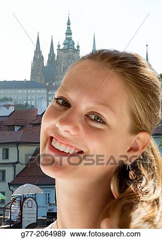Portrait of a young woman smiling, Prague, Czech Republic View Large Photo Image Stock Photo - Portrait of a young woman smiling, Prague, Czech Republic. Fotosearch