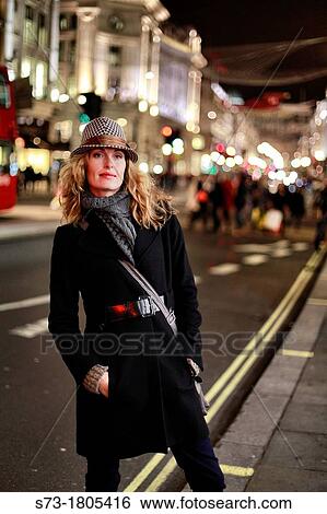 Portrait of a young woman smiling, Regent Street, London, England View Large Photo Image Stock Photograph - Portrait of a young woman smiling, Regent Street, London, England. Fotosearch