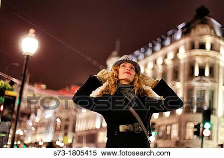 Stock Photography - Portrait of a young woman smiling, Regent Street, London, England. Fotosearch