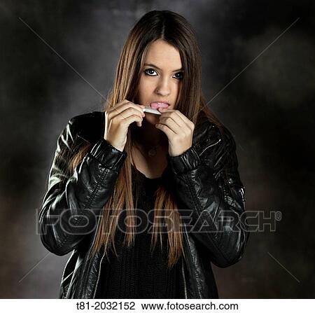 Portrait of a young woman smoking View Large Photo Image Stock Image - Portrait of a young woman smoking. Fotosearch