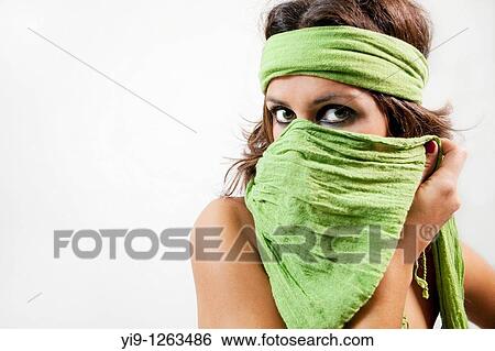 Stock Photograph - Portrait of a young woman wearing a headscarf looking at camera. Fotosearch