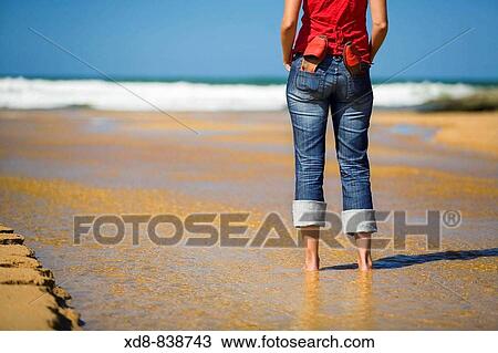 Portrait of a young woman with a pair of sandals on the beach View Large Photo Image Stock Image - Portrait of a young woman with a pair of sandals on the beach. Fotosearch