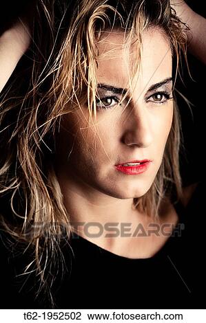 Stock Image - Portrait of a young woman with blond hair.. Fotosearch