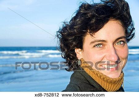 Portrait of a young woman with blue eyes smiling View Large Photo Image Stock Image - Portrait of a young woman with blue eyes smiling. Fotosearch