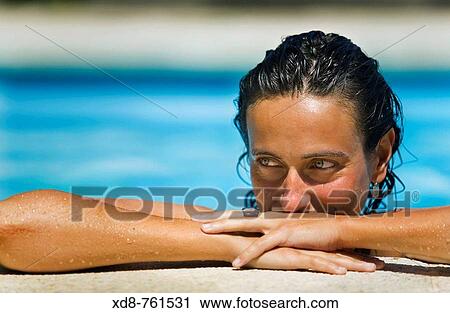 Portrait of a young woman with blue eyes in a swimming pool View Large Photo Image Stock Image - Portrait of a young woman with blue eyes in a swimming pool. Fotosearch
