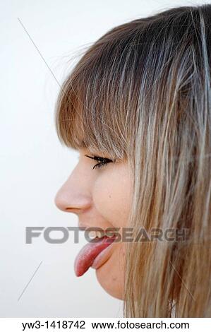 Portrait of a young woman with her tongue out in profile View Large Photo Image Stock Image - Portrait of a young woman with her tongue out in profile. Fotosearch