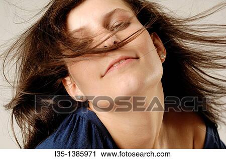 Portrait of a young woman with wind in her hair View Large Photo Image Stock Image - Portrait of a young woman with wind in her hair. Fotosearch