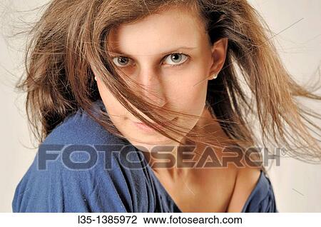 Portrait of a young woman with wind in her hair View Large Photo Image Stock Image - Portrait of a young woman with wind in her hair. Fotosearch