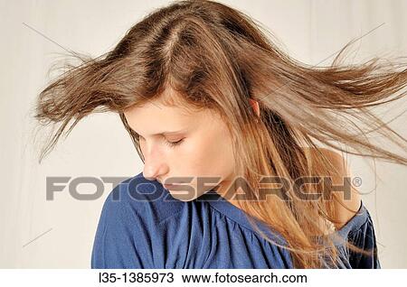 Portrait of a young woman with wind in her hair View Large Photo Image Stock Image - Portrait of a young woman with wind in her hair. Fotosearch