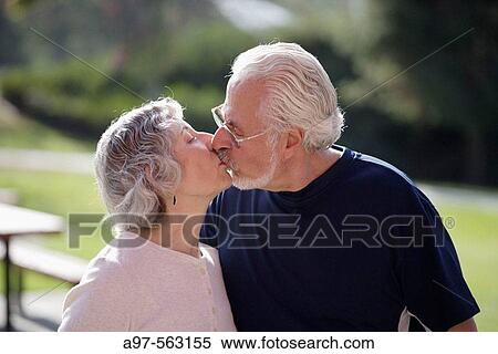 Portrait of active senior couple in exercise clothes kissing each other in an outdoor park. View Large Photo Image Stock Photography - Portrait of active senior couple in exercise clothes kissing each other in an outdoor park.. Fotosearch