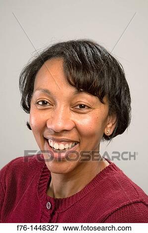 Portrait of African American woman with short black hair wearing a maroon sweater View Large Photo Image Stock Photo - Portrait of African American woman with short black hair wearing a maroon sweater. Fotosearch