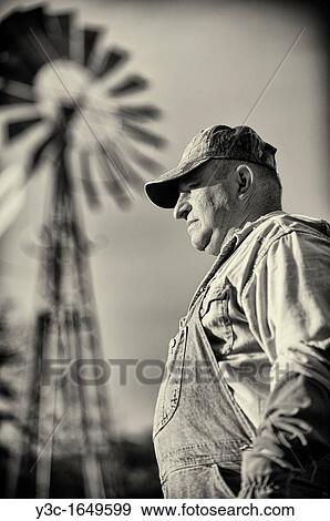 Portrait of American Farmer Vintage Style Black and White with Ranch Windmill in Background View Large Photo Image Stock Photo - Portrait of American Farmer Vintage Style Black and White with Ranch Windmill in Background. Fotosearch