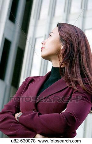 Portrait of an Asian-American businesswoman in front of a high-rise office building, Financial District, San Francisco, California, USA. View Large Photo Image Stock Photo - Portrait of an Asian-American businesswoman in front of a high-rise office building, Financial District, San Francisco, California, USA.. Fotosearch