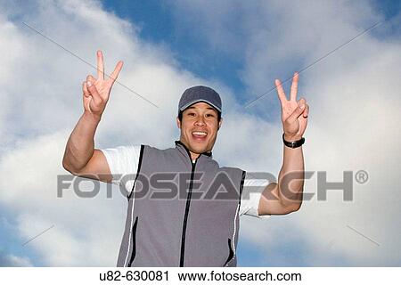 Stock Image - Portrait of an athletic young Asian man.. Fotosearch