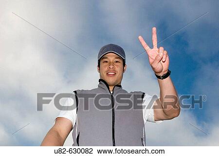 Stock Image - Portrait of an athletic young Asian man.. Fotosearch