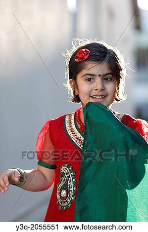 Stock Image - Portrait of an indian american girl playing outdoors.. Fotosearch