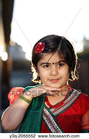 Stock Image - Portrait of an indian american girl playing outdoors.. Fotosearch