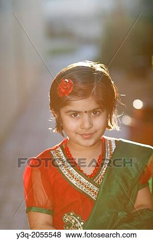 Stock Photo - Portrait of an indian american girl playing outdoors.. Fotosearch