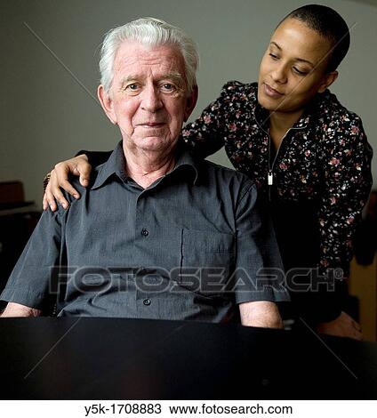 Portrait of an older, Dutch man, sitting at a diner-table, while his daughter approaches him from the back. View Large Photo Image Stock Image - Portrait of an older, Dutch man, sitting at a diner-table, while his daughter approaches him from the back.. Fotosearch