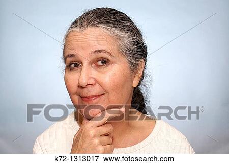Stock Photo - Portrait of an older woman with an inquisitive look. Fotosearch