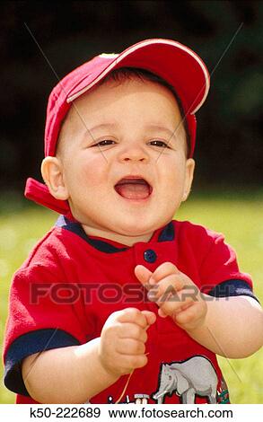 Stock Photo - Portrait of baby wearing baseball cap. Amsterdam. Netherlands. Fotosearch