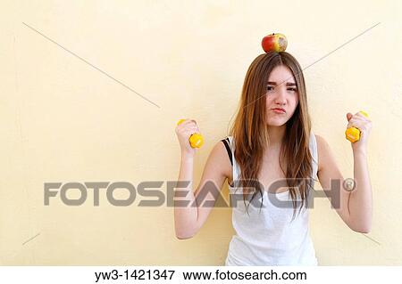 Portrait of beautiful brunette woman holding a red apple View Large Photo Image Stock Photo - Portrait of beautiful brunette woman holding a red apple. Fotosearch
