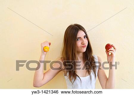 Portrait of beautiful brunette woman holding a red apple View Large Photo Image Stock Photograph - Portrait of beautiful brunette woman holding a red apple. Fotosearch